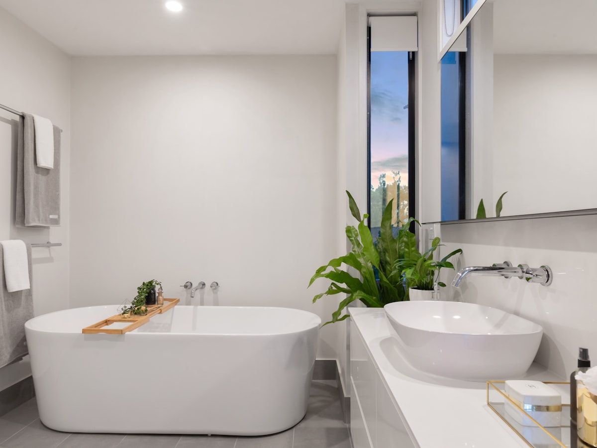 Bathroom with a walk-in shower, a wall-hung vanity unit and light tiling