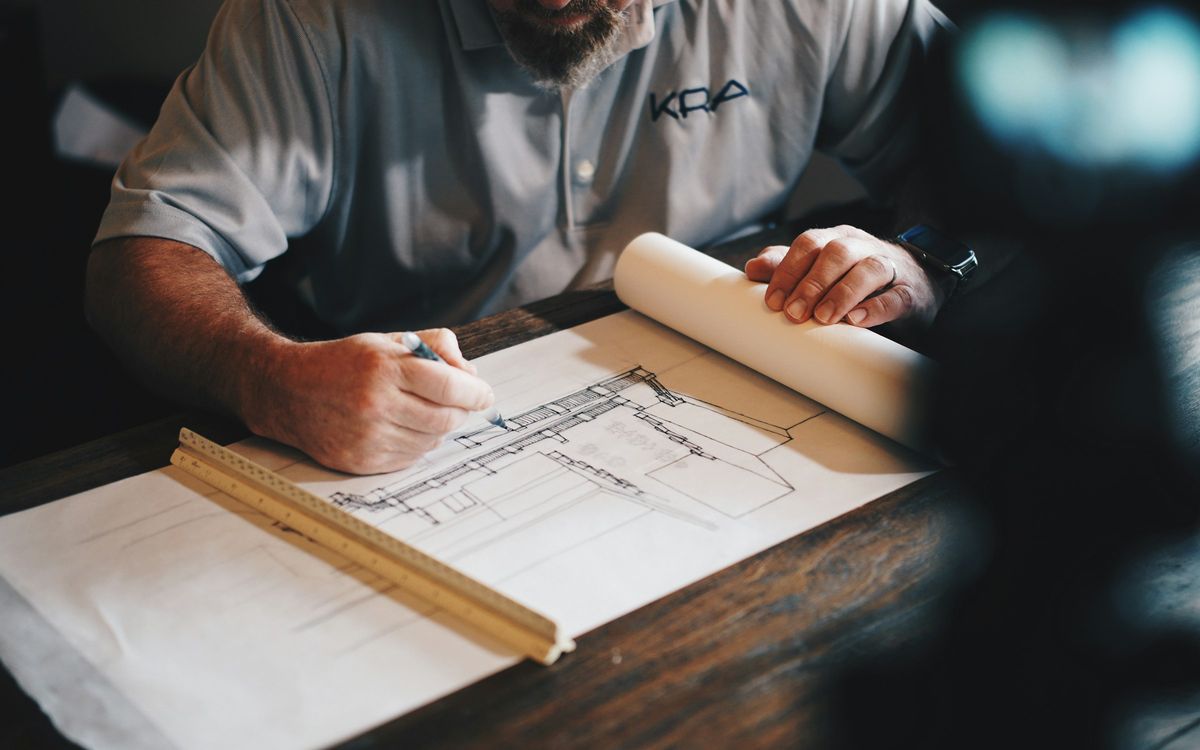Preparing a renovation quote over the plans of a property