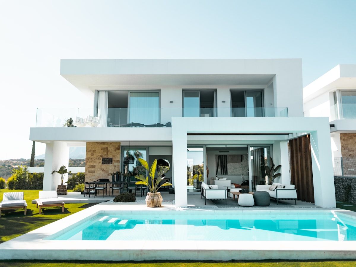 Completed concrete swimming pool at a home in Mallorca, with stone coping and sun deck
